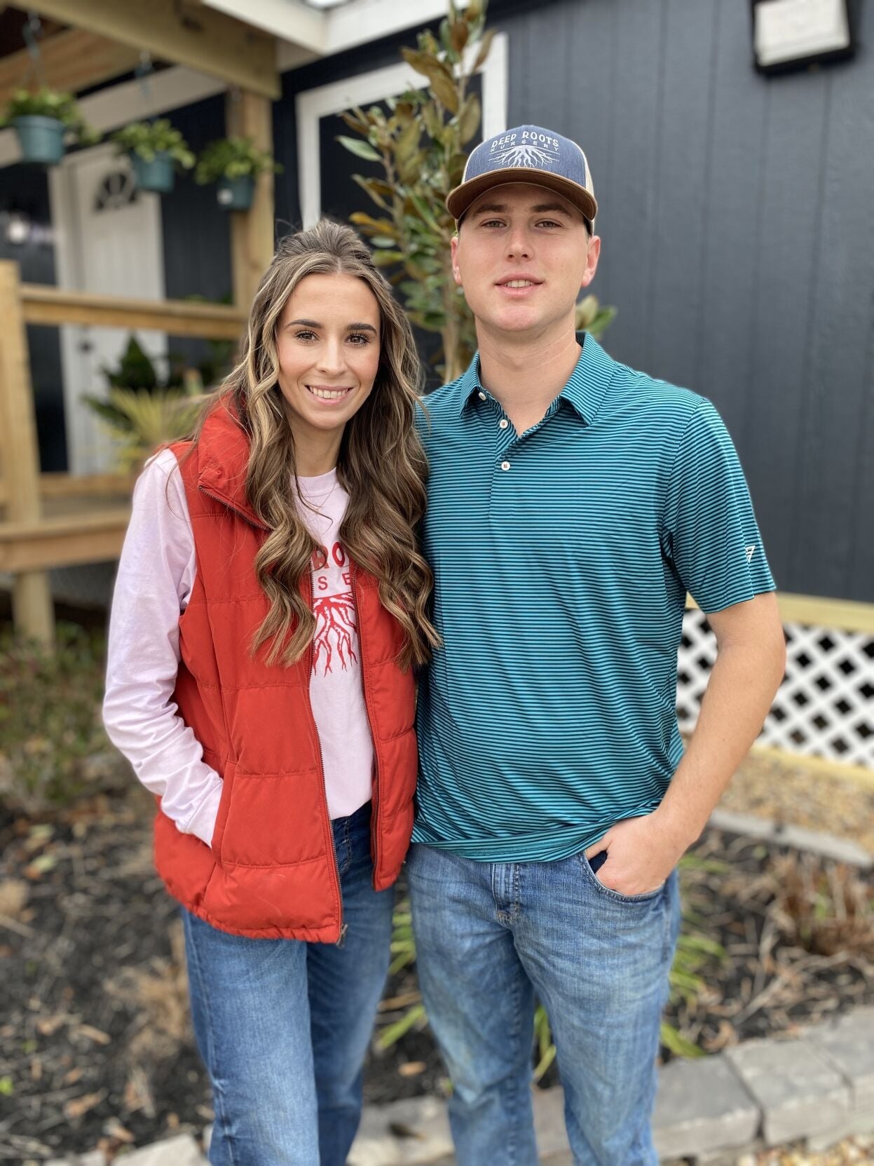 Chase and Madison Johnson, owners of Deep Roots Nursery, standing outside the Baytown yard